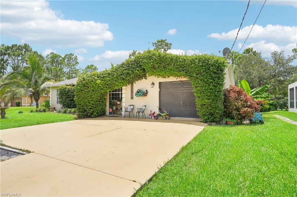 a front view of a house with a yard and garage