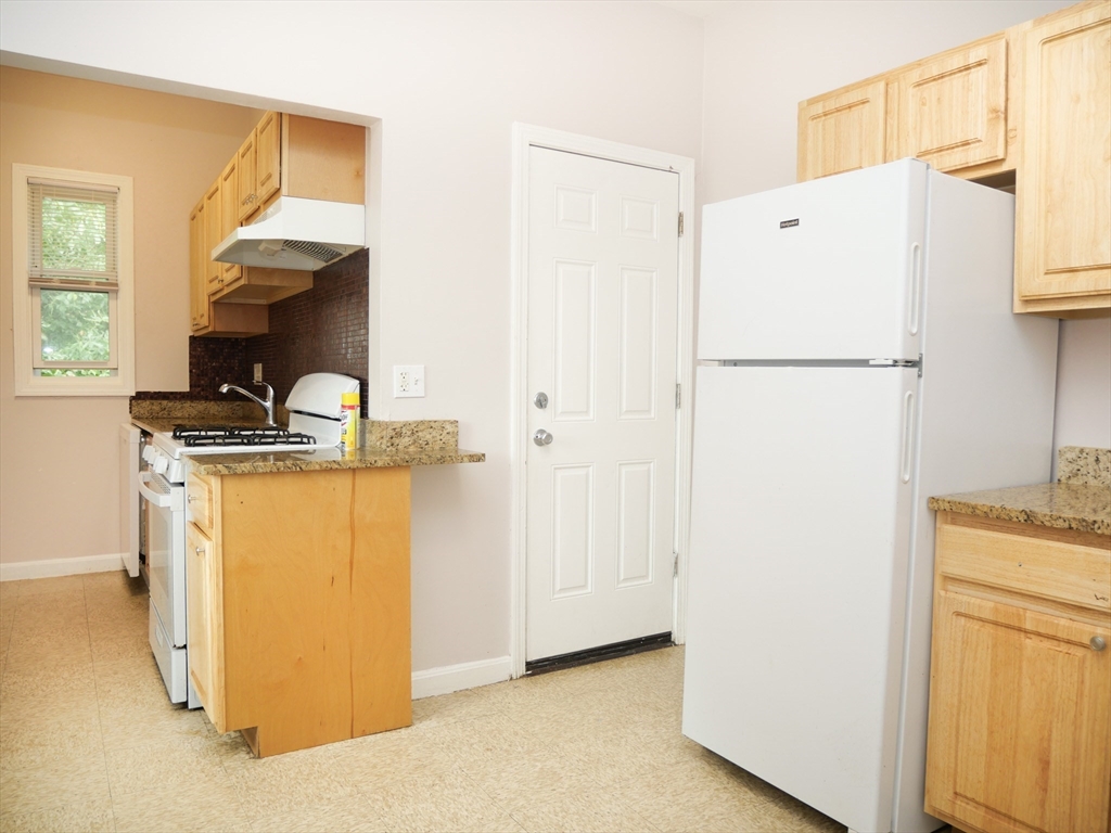 a utility room with cabinets washer and dryer