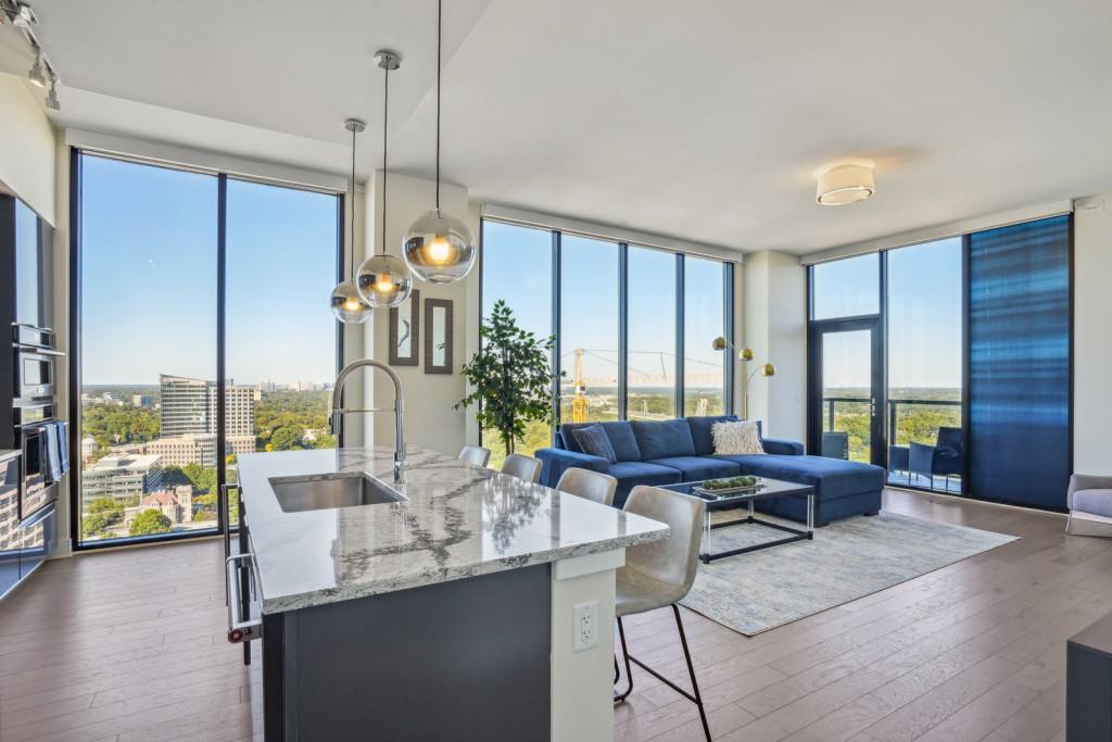 a living room with furniture and floor to ceiling windows