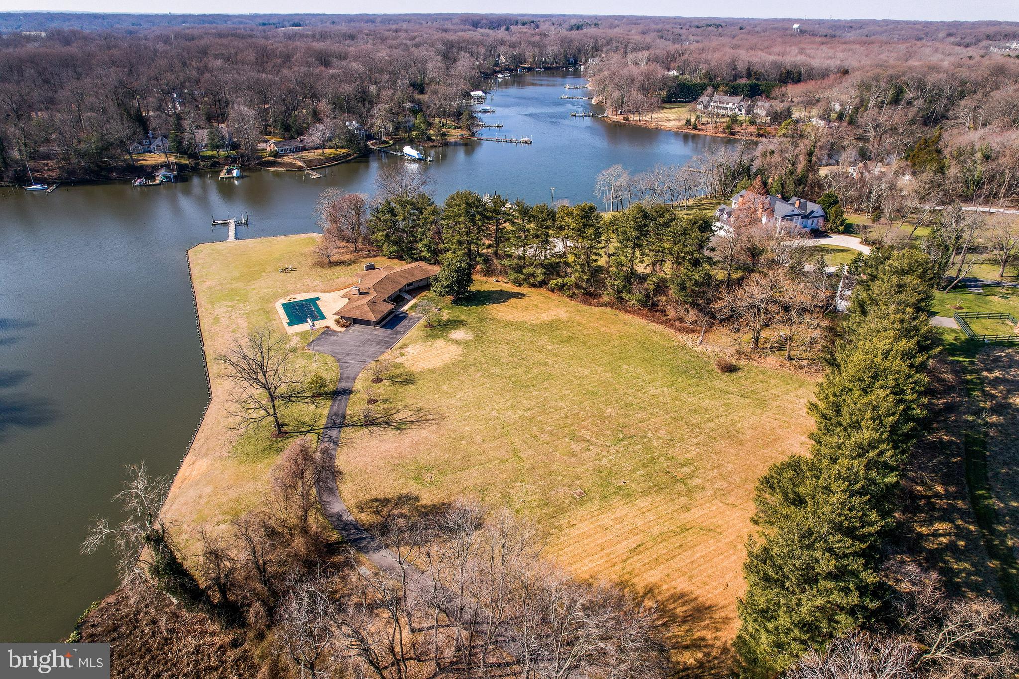 an aerial view of residential houses with outdoor space and lake view