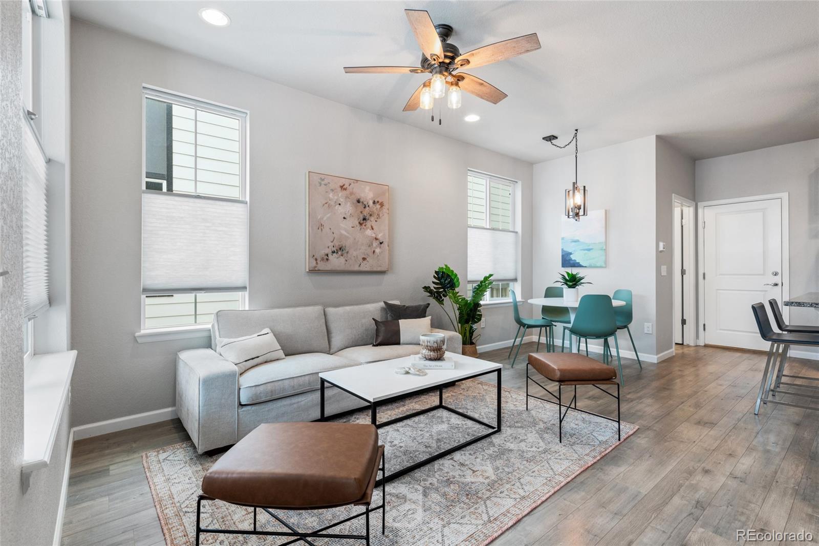 a living room with furniture a chandelier and a window