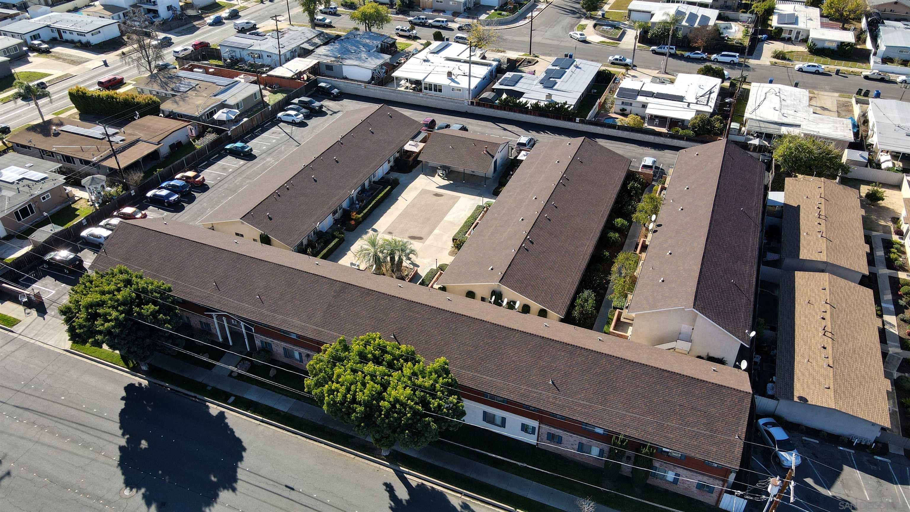 an aerial view of a residential apartment building with a yard