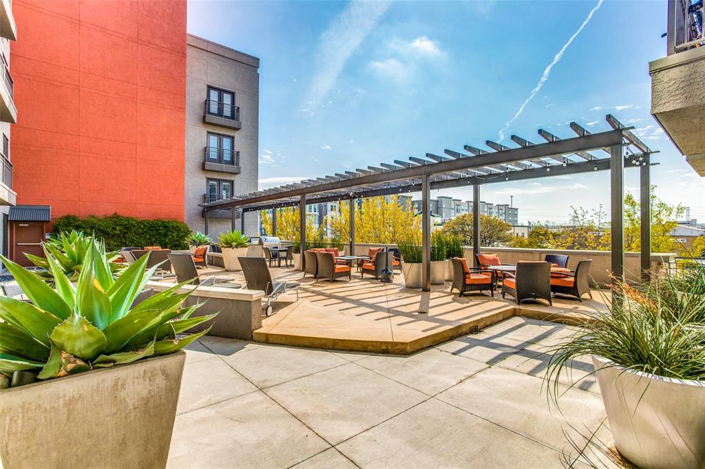 a view of a patio with a table and chairs potted plants