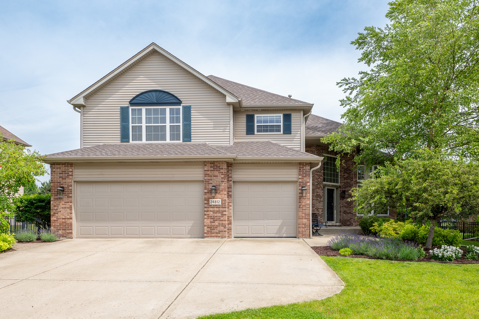 a front view of a house with a yard and garage