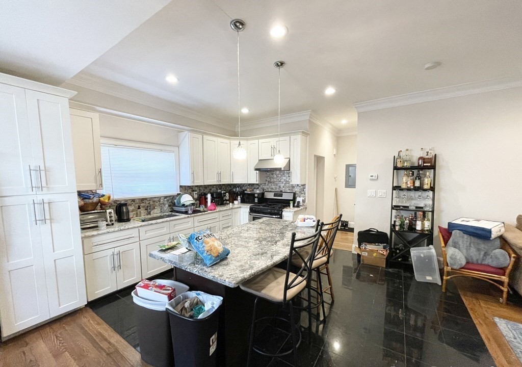 a view of a dining room with furniture kitchen and wooden floor