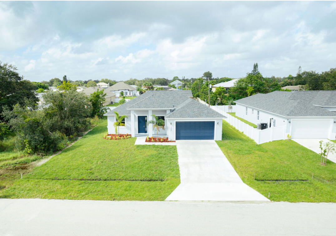 a aerial view of a house with table and chairs