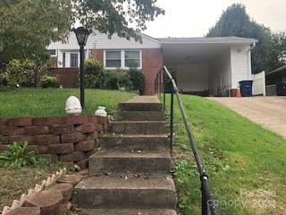 a front view of a house with a garden and plants