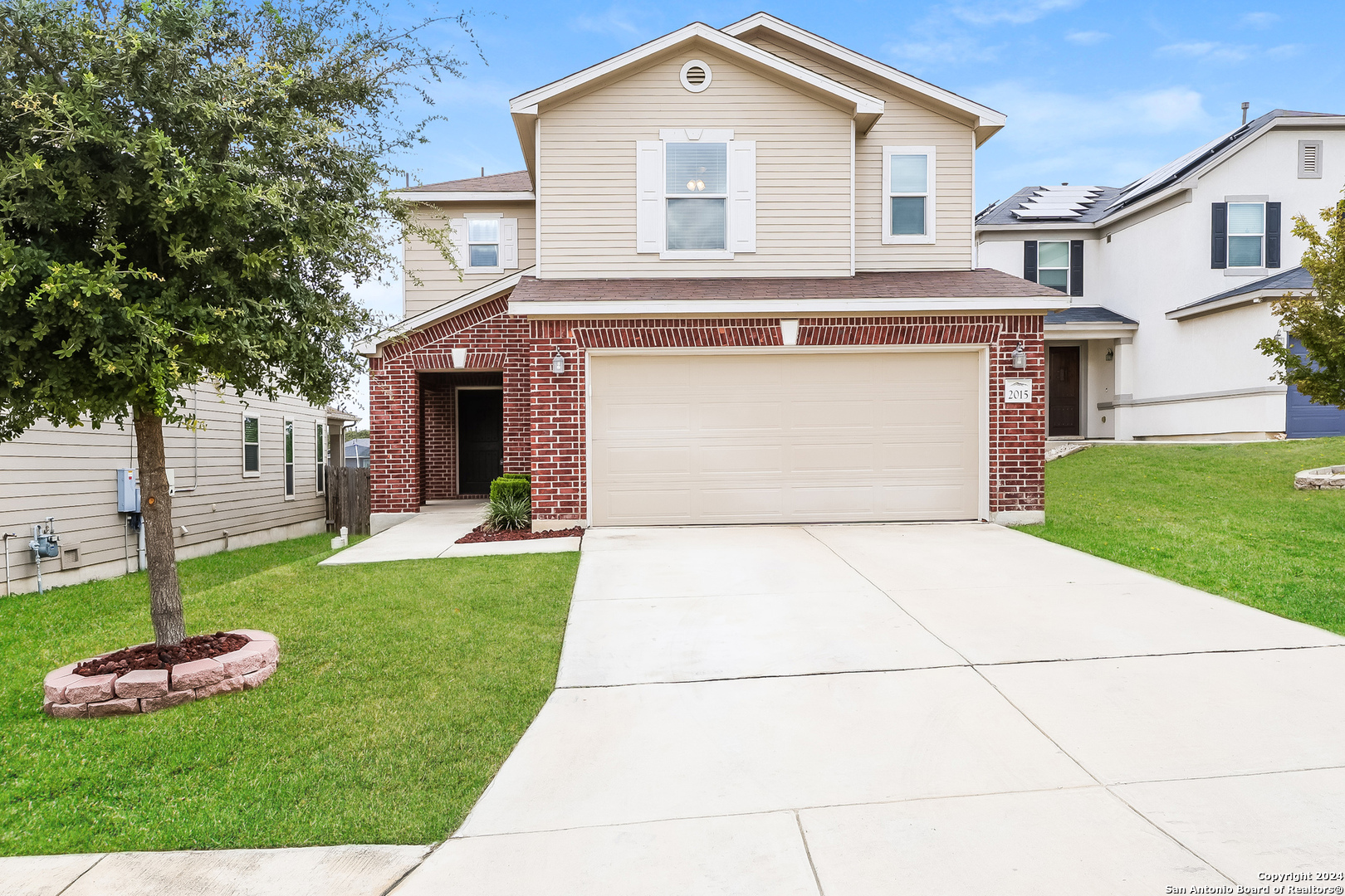 a front view of a house with a yard and garage