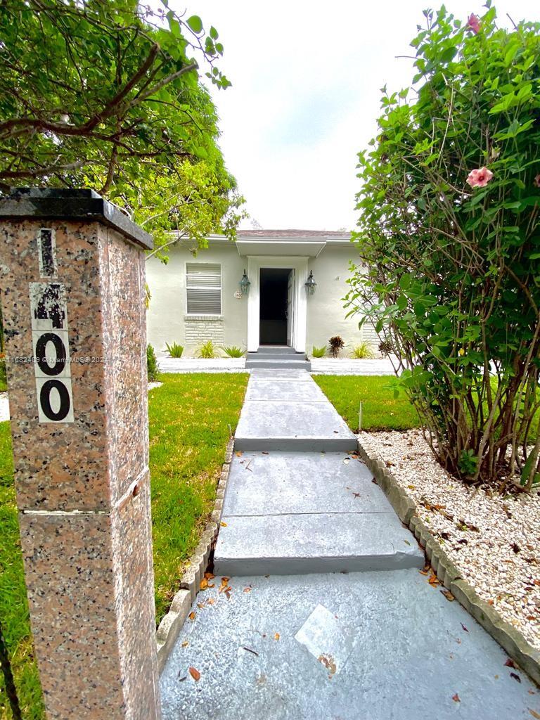 a front view of a house with garden