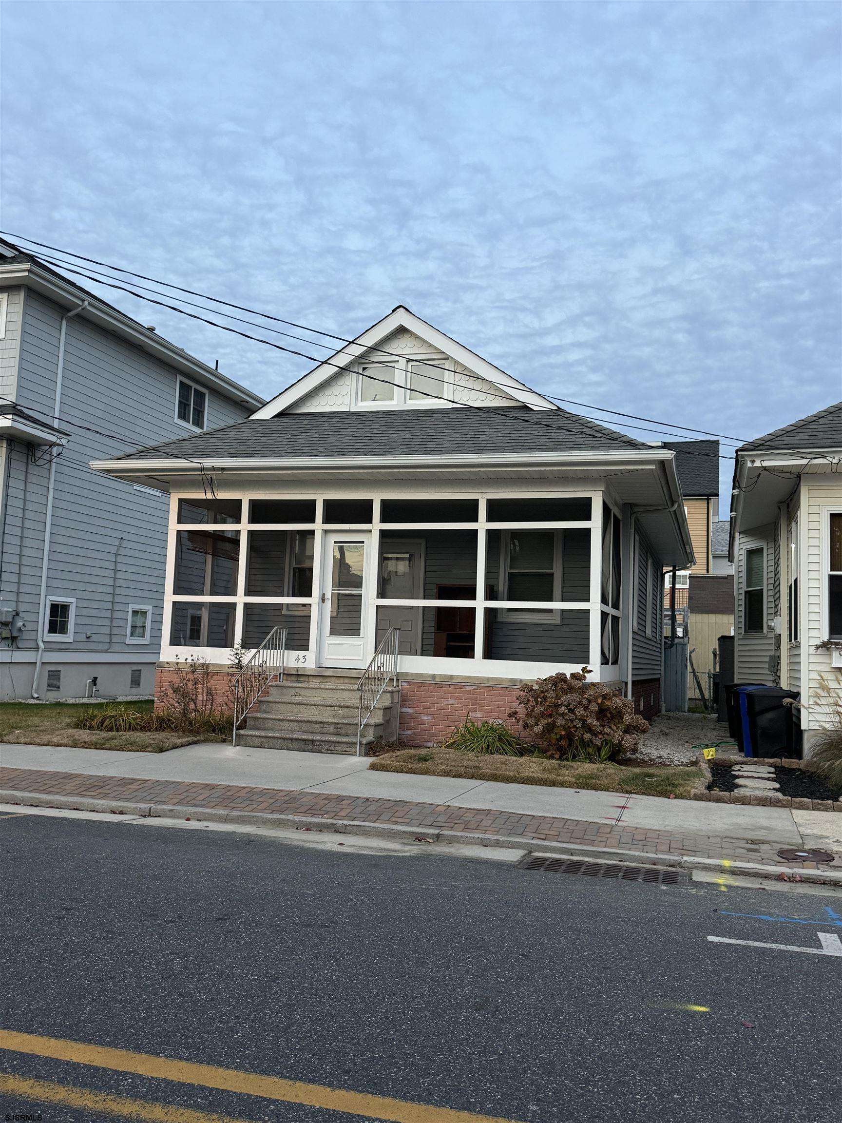 a front view of a house with a yard and sitting space