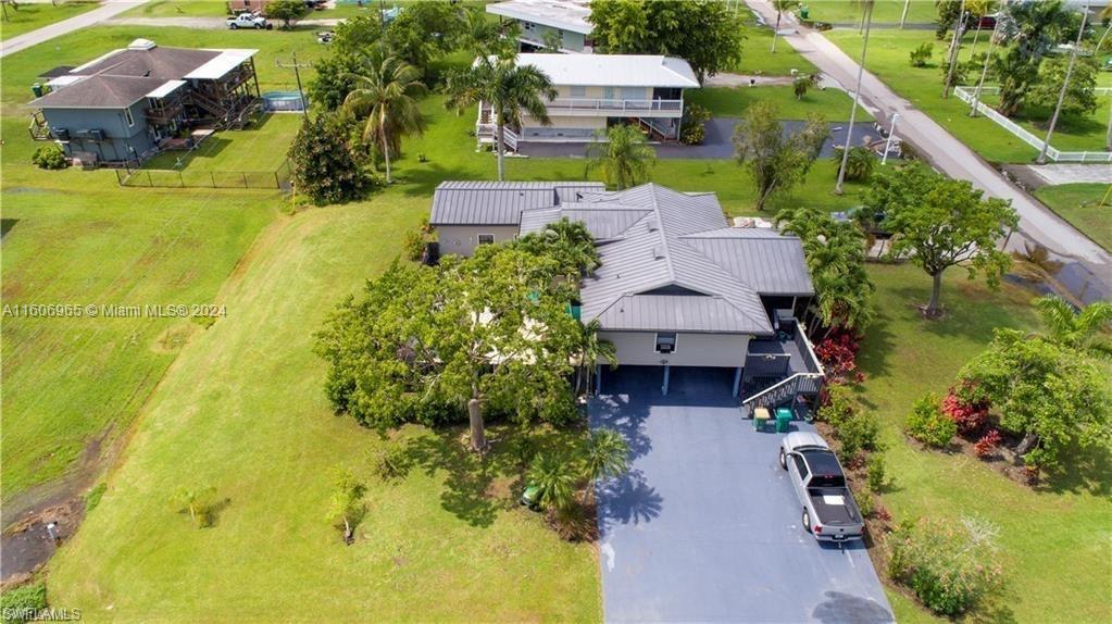 an aerial view of house with yard swimming pool and outdoor seating