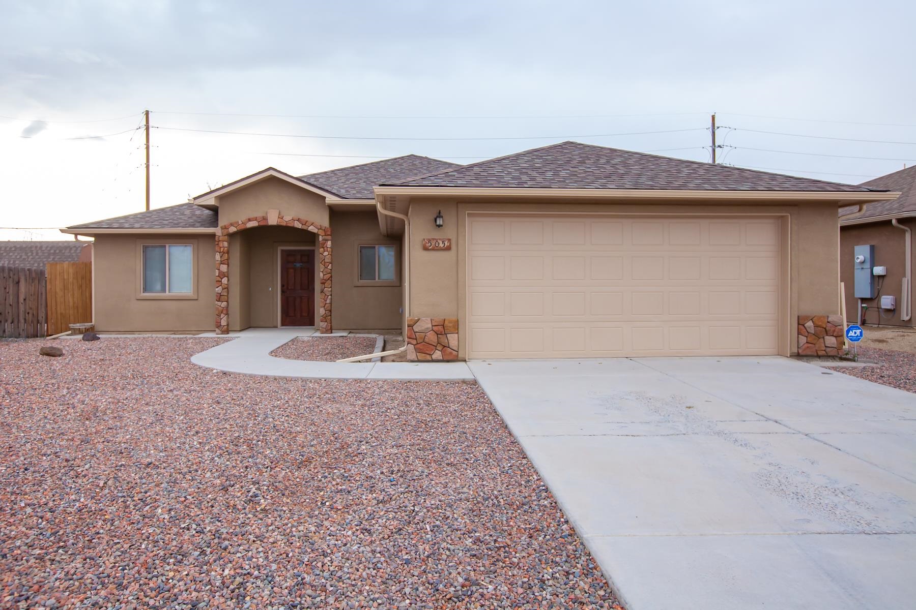 a view of a house with a yard and garage