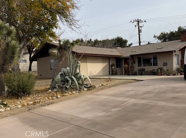 a front view of a house with basket ball court and a garage