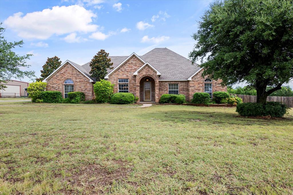 a front view of house with yard and green space