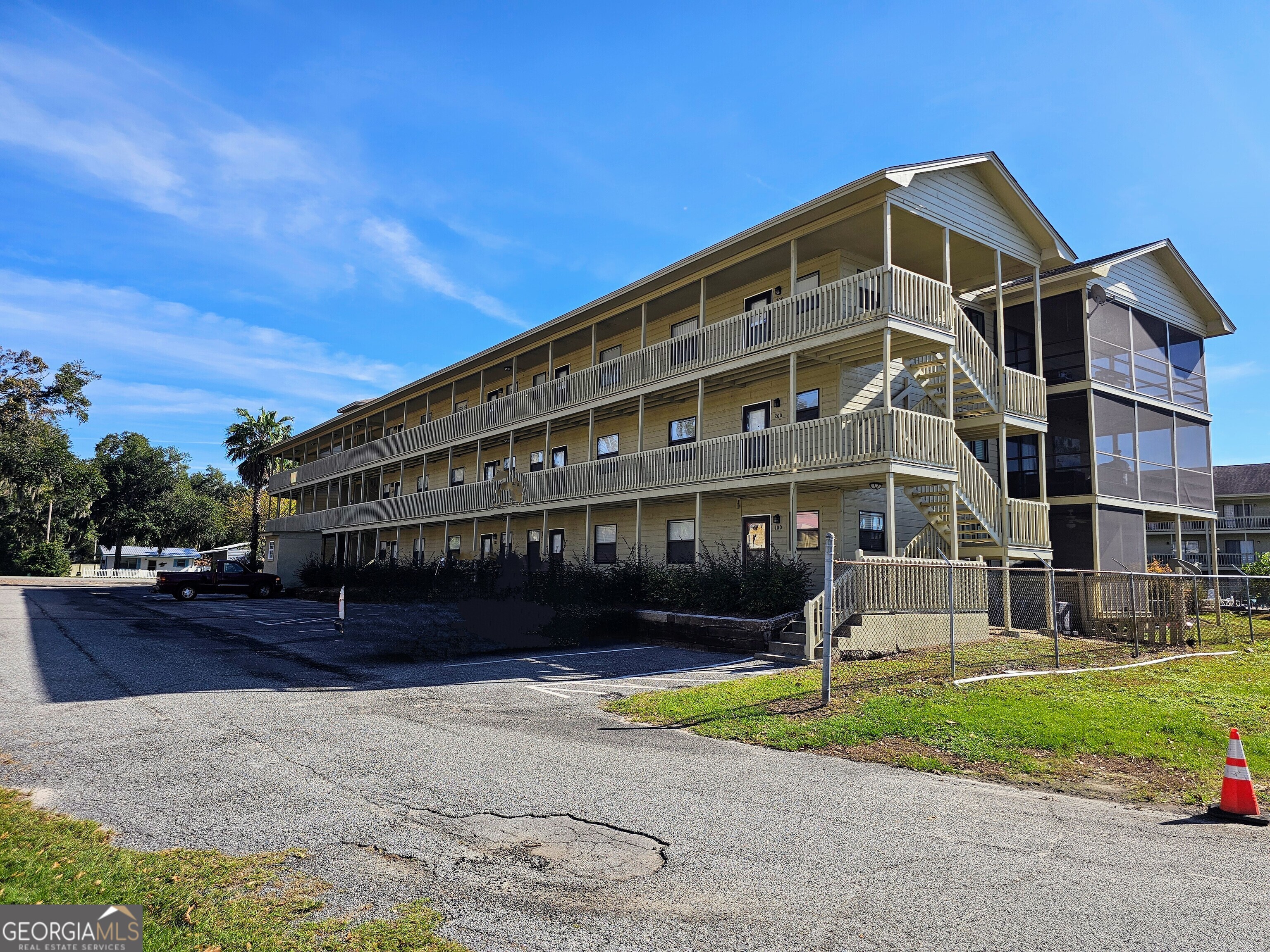 a front view of a building with a garden