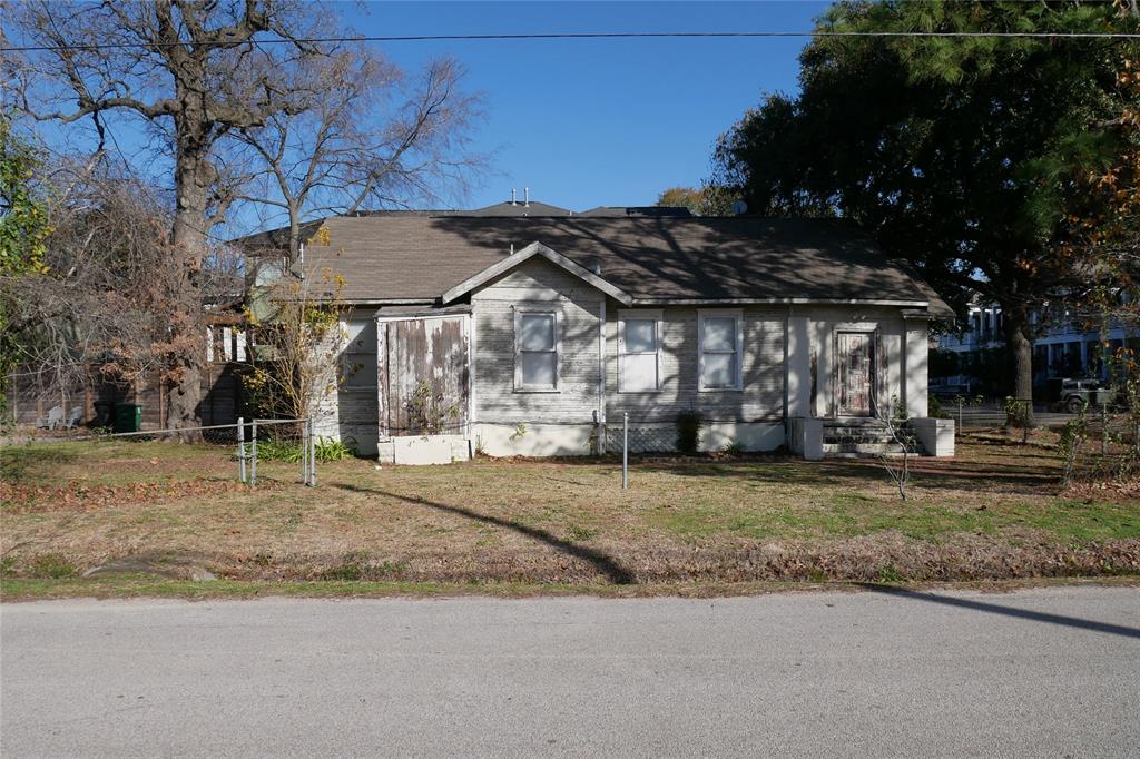 a view of a house with a backyard and trees