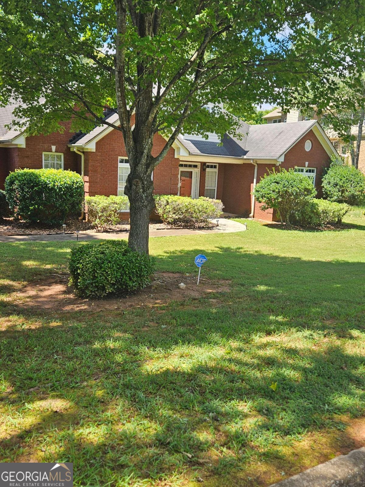 a front view of house with yard and green space