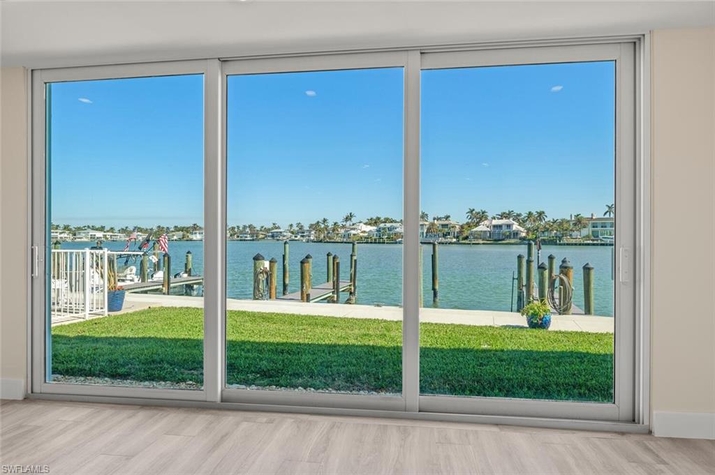 Entryway with hardwood / wood-style flooring and a water view