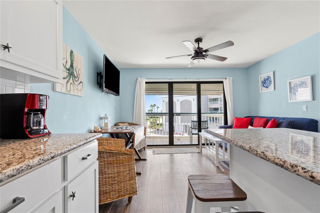 a living room with furniture a flat screen tv and a large window