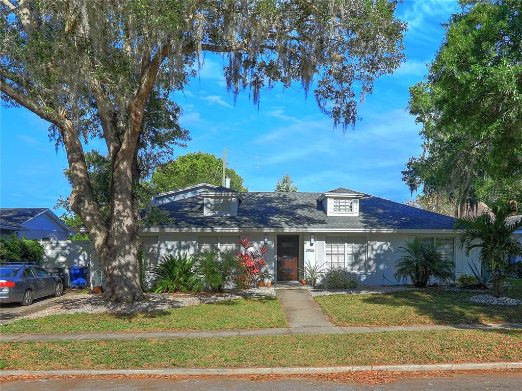 a view of a large building in a yard with lawn chairs