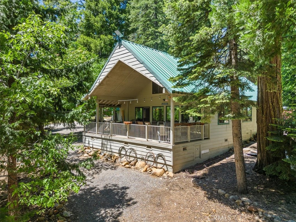 a view of a house with backyard and sitting area