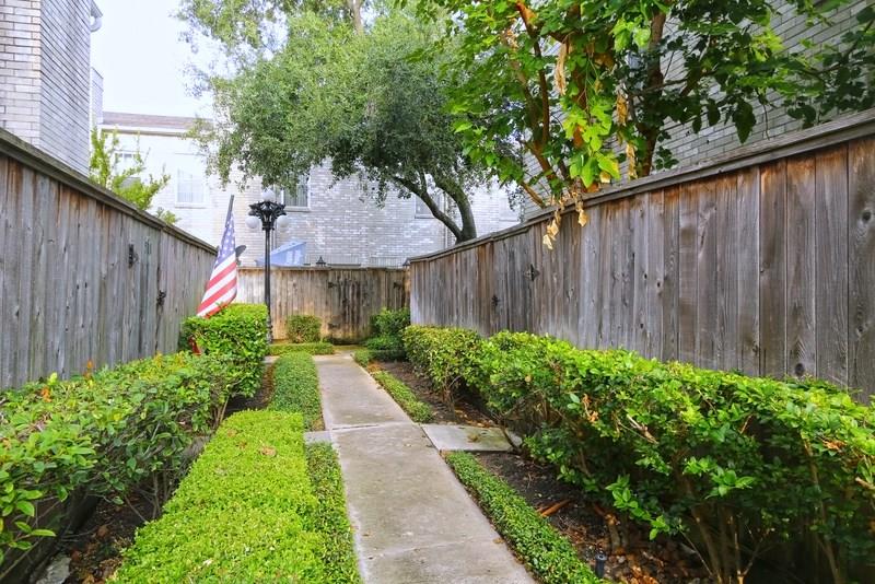 a view of flower garden with wooden fence