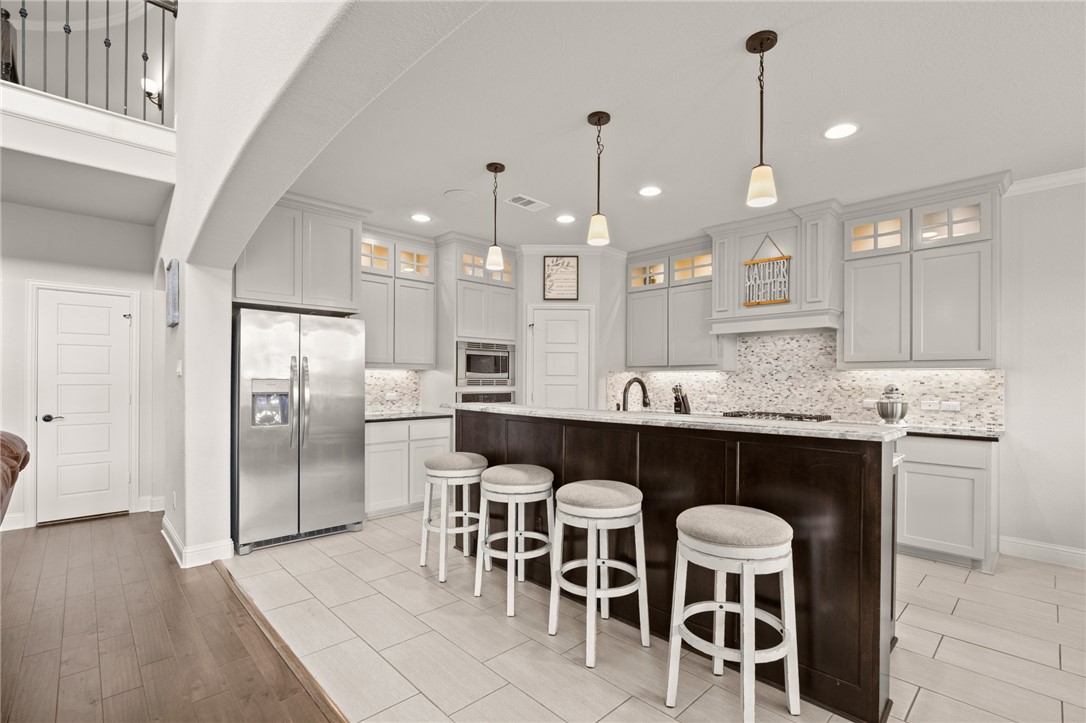 a large kitchen with a table and chairs