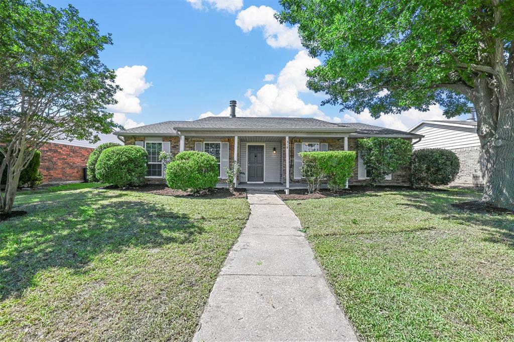 a front view of a house with yard