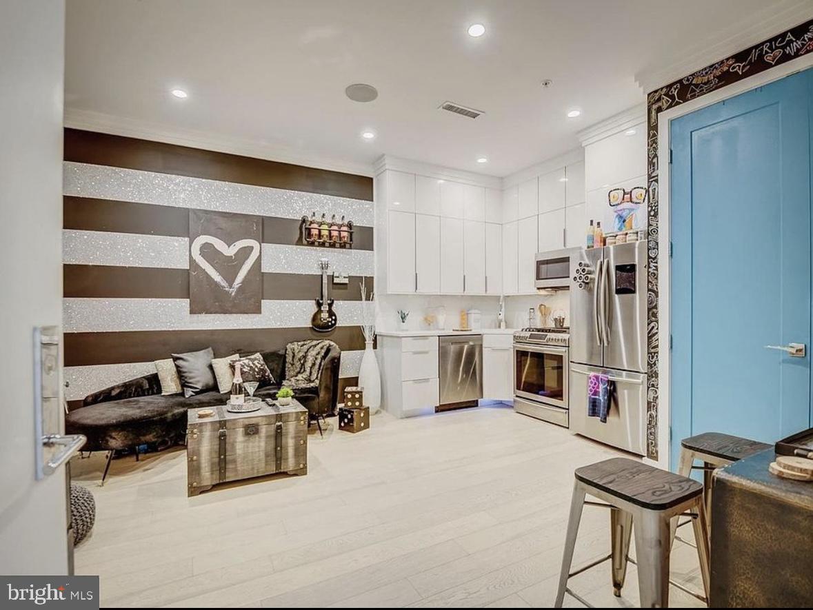 a kitchen with stainless steel appliances granite countertop a sink and cabinets