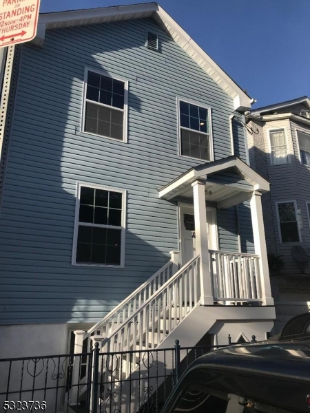 a front view of a house with stairs