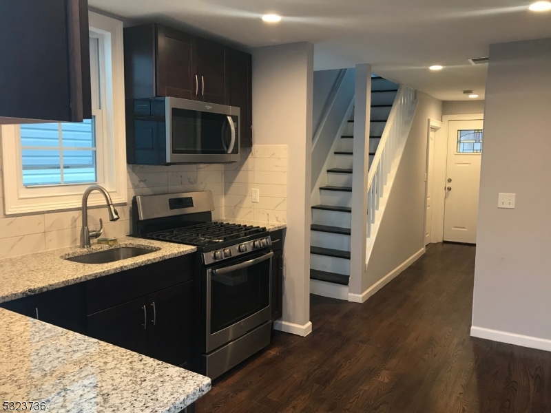 a kitchen with stainless steel appliances granite countertop a stove and a sink