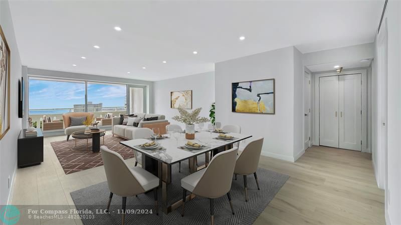 a dining room with stainless steel appliances kitchen island granite countertop a table and chairs