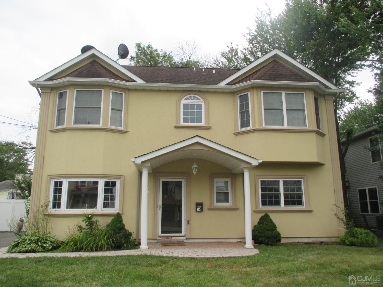 a front view of a house with a yard