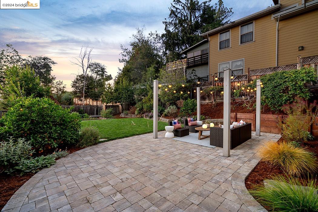 a view of a patio with couches table and chairs and potted plants