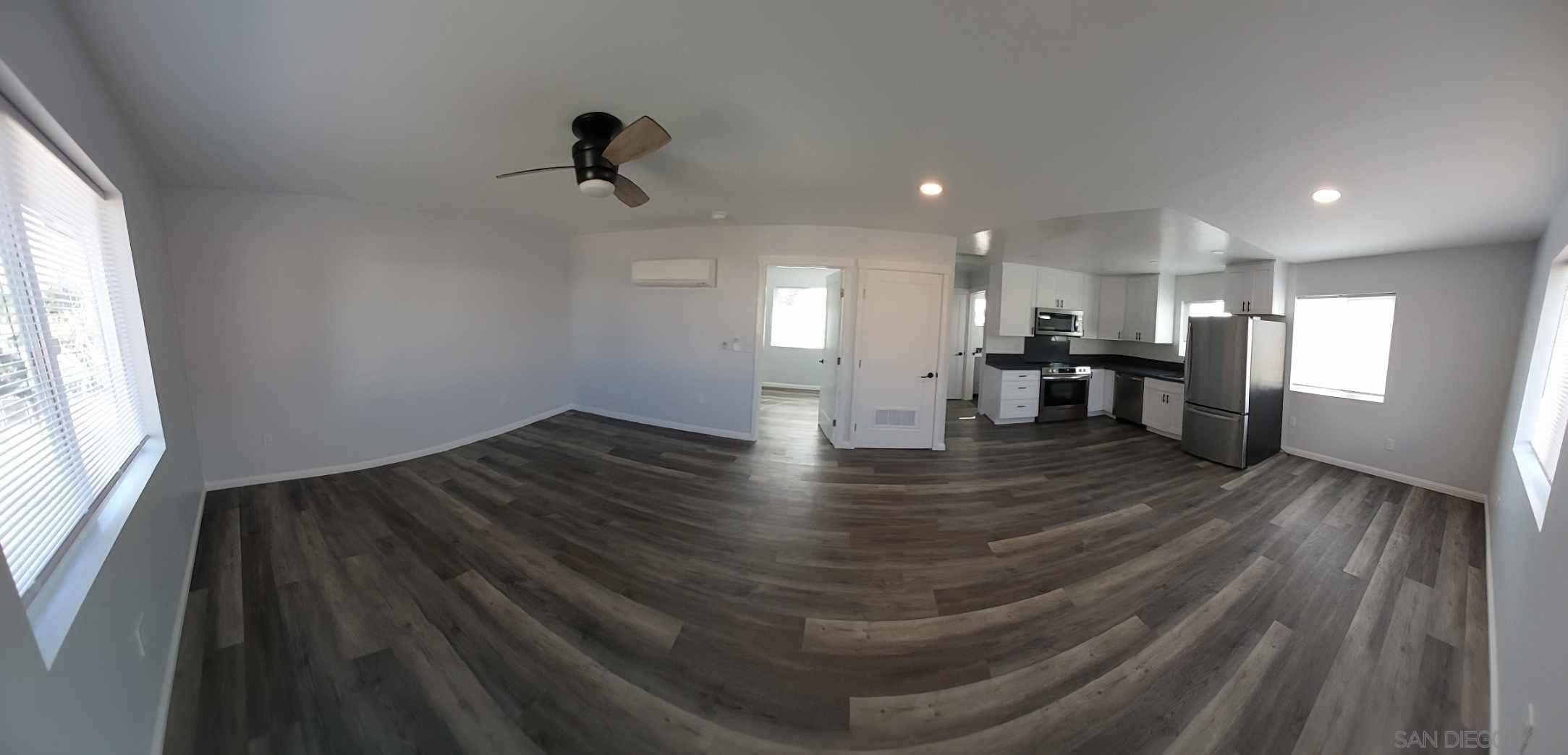 a view of kitchen and hall with wooden floor