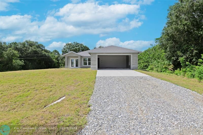 a view of house with yard and entertaining space