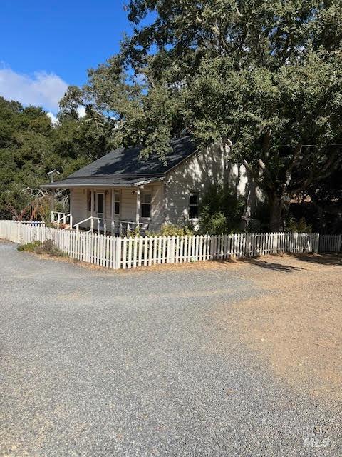 a view of a house with a wooden fence