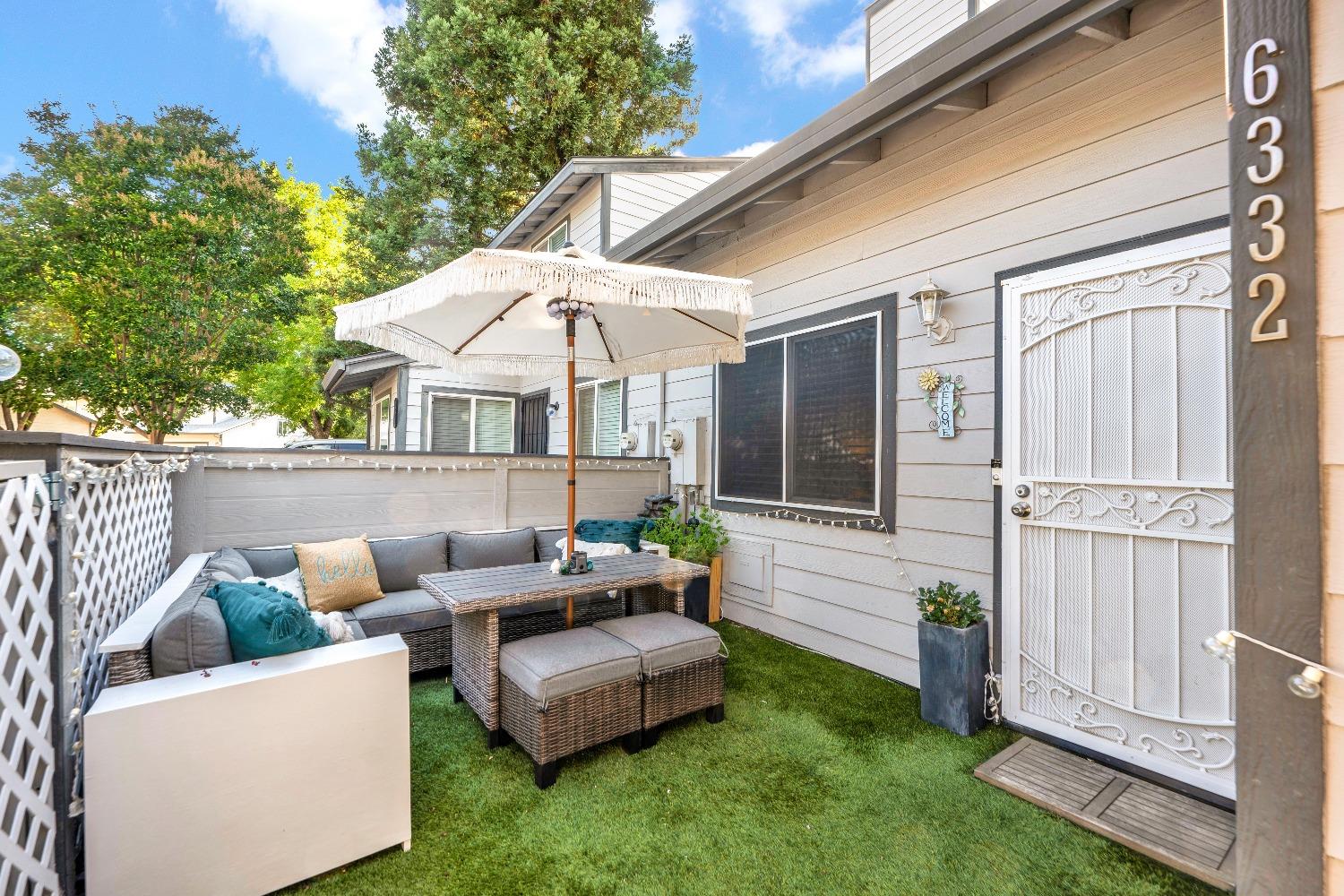 a view of a house with a backyard and a patio