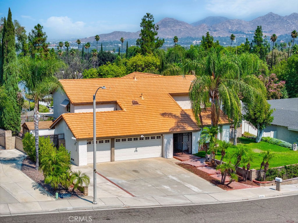 an aerial view of a house with a garden and plants