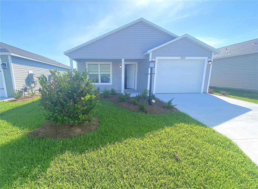 a view of an house with backyard space and garden