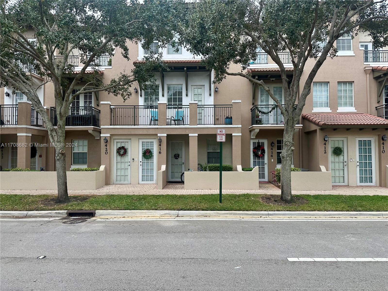 front view of a brick house with a yard