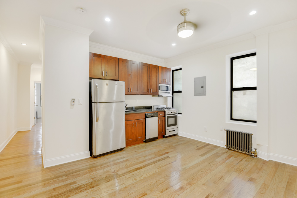 a kitchen with stainless steel appliances granite countertop a refrigerator sink and cabinets