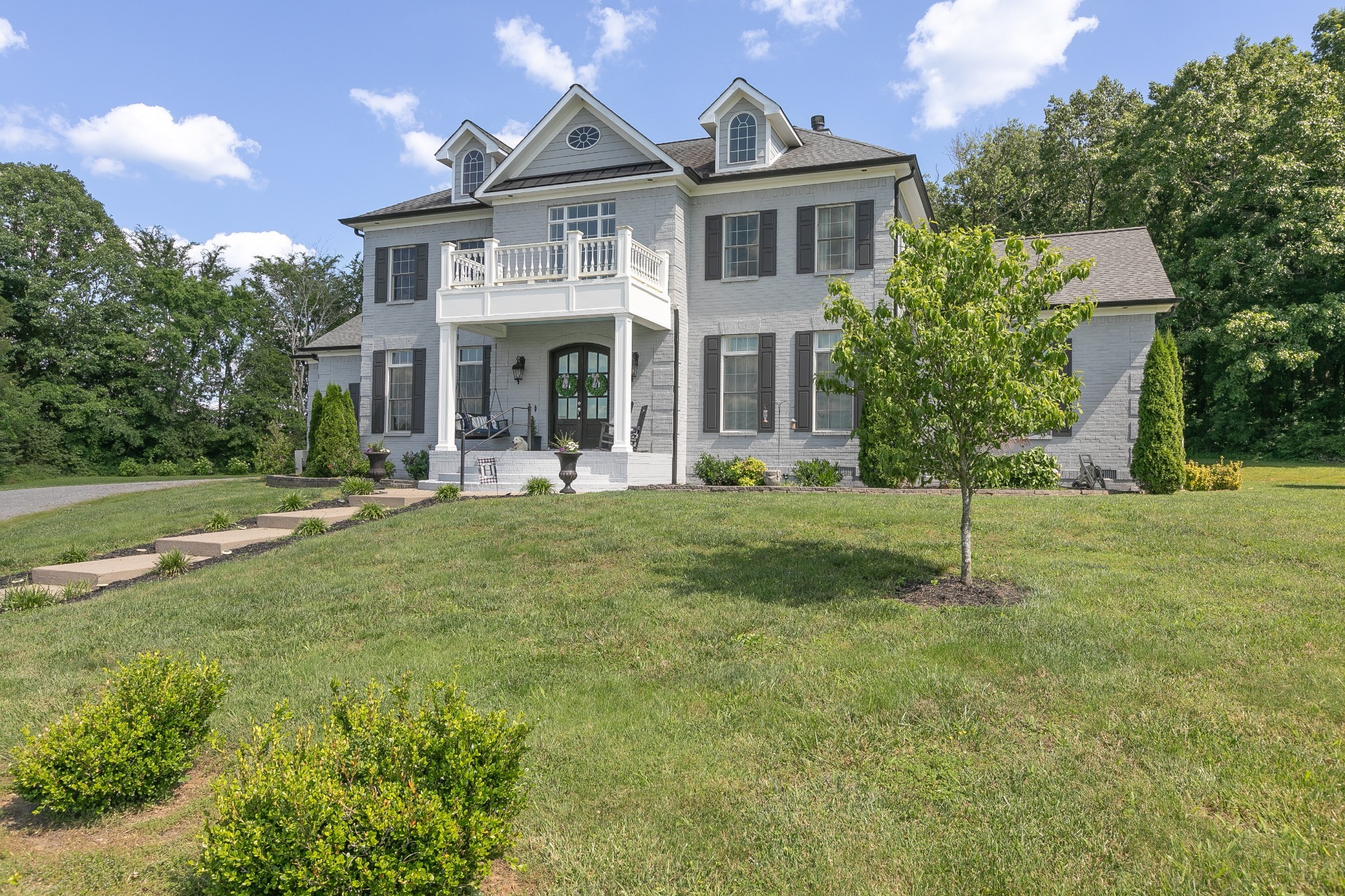 a front view of a house with a yard