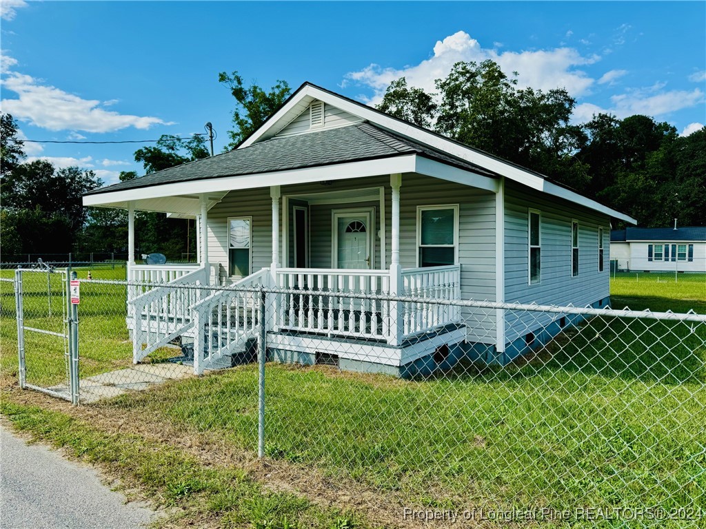 a view of a house with a yard and a garden