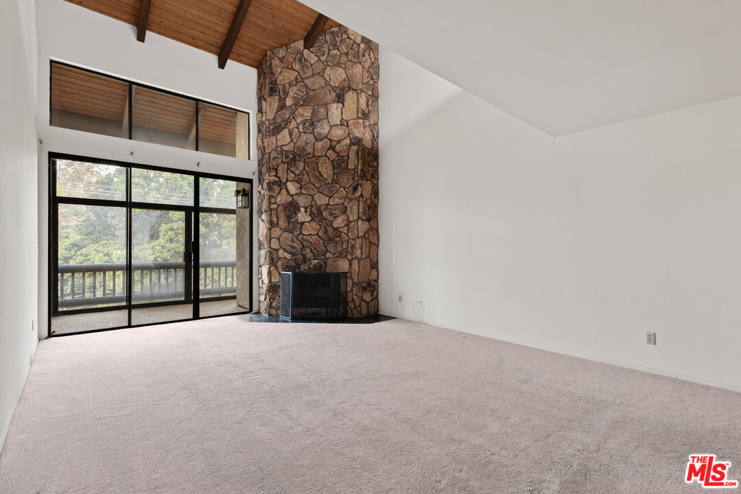 a view of an empty room with a balcony