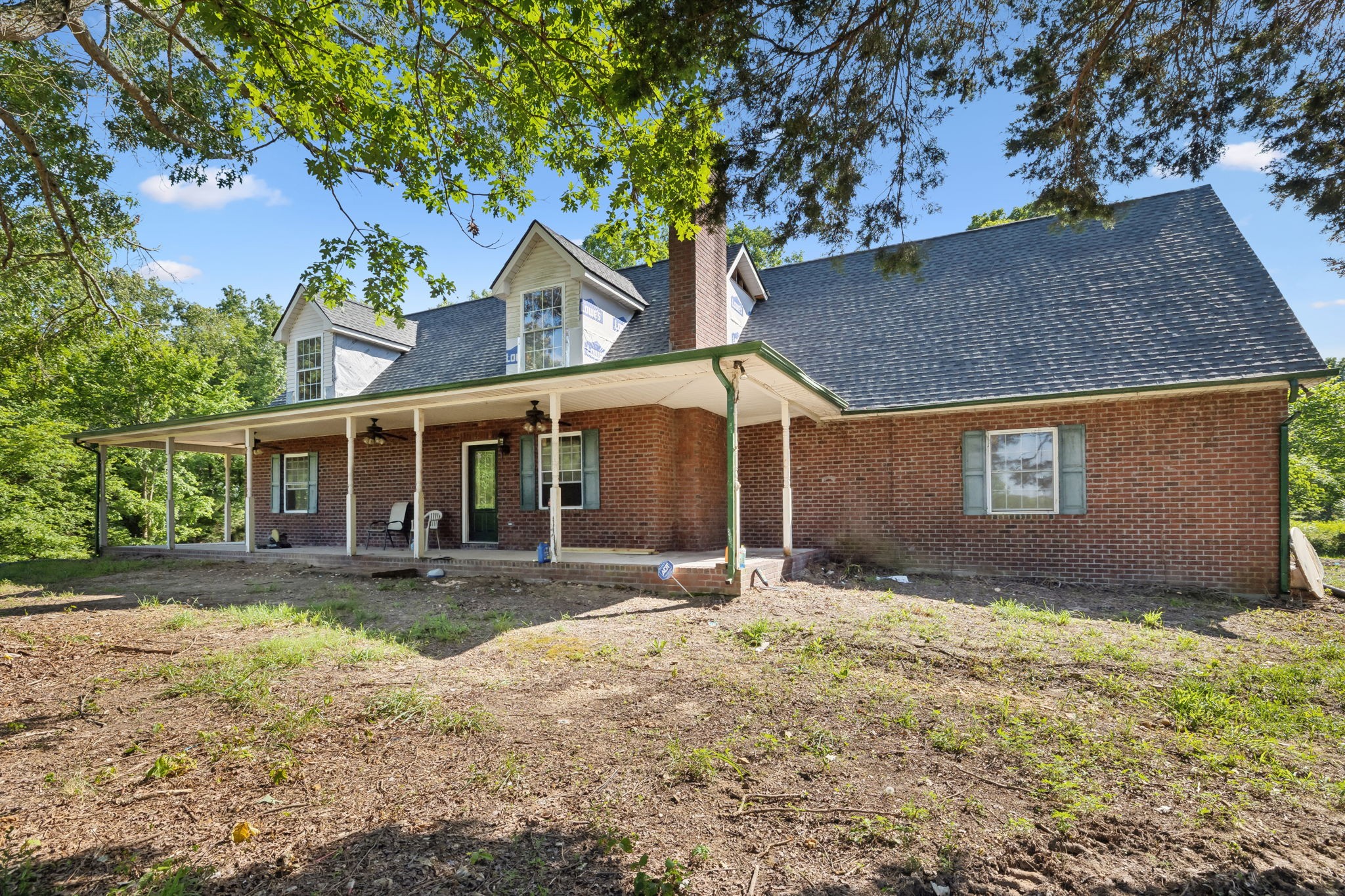 a view of a house with a yard and sitting area