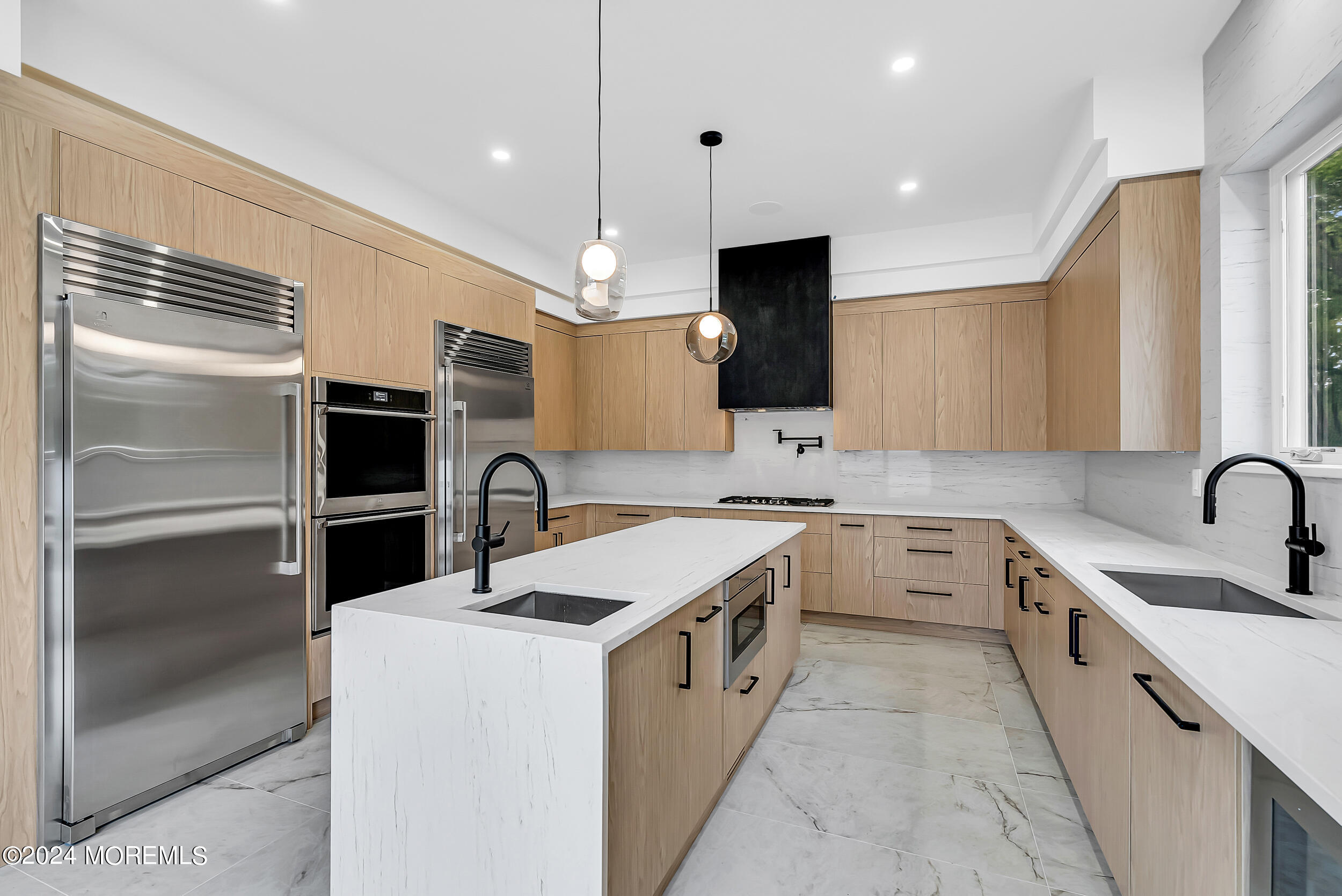 a kitchen with a sink stainless steel appliances and cabinets