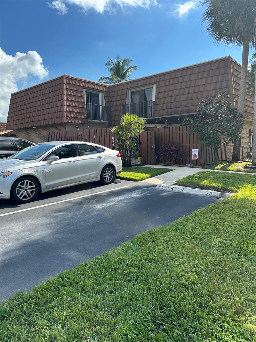 a view of a car parked in front of a house