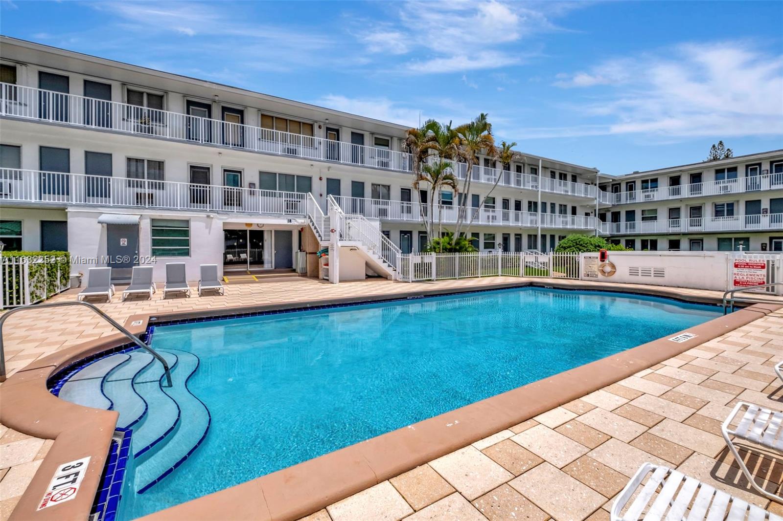 a view of swimming pool with outdoor seating