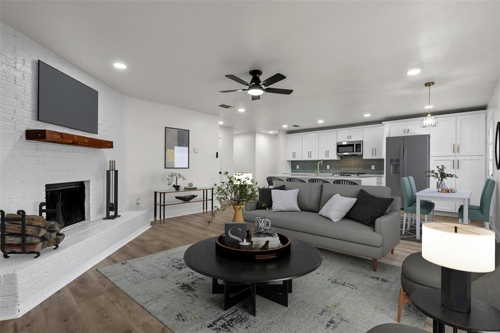 a living room with furniture a fireplace and a ceiling fan